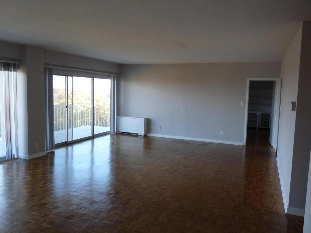 Central Gardens Living Salon Before: Stark white drywall, bare parquet floors, and empty walls