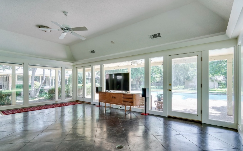 Clarksdale Living Room Pool View Before: Bare unshaded French doors