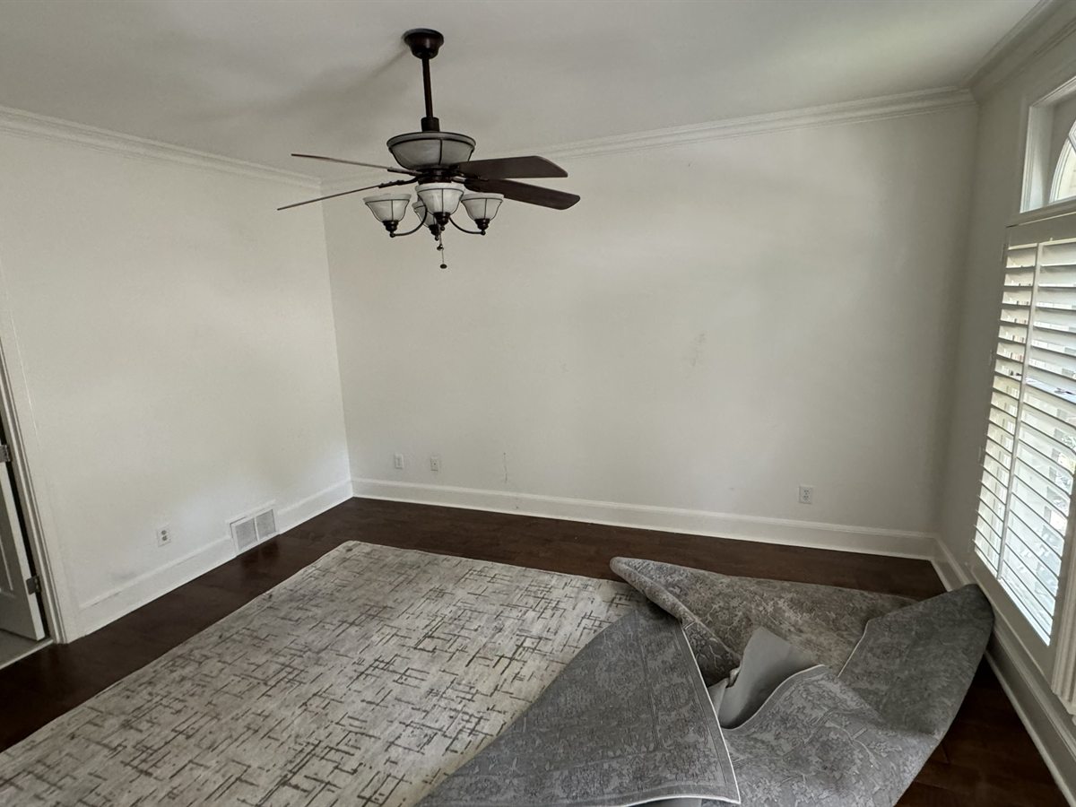 Southwind Downstairs Bedroom Before: Stark white drywall and cold acoustics