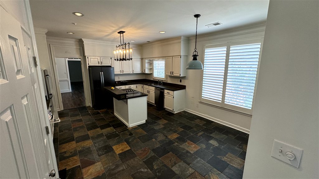 Kitchen & Breakfast Room Before: Stark builder-white cabinets and ungrounded slate floor