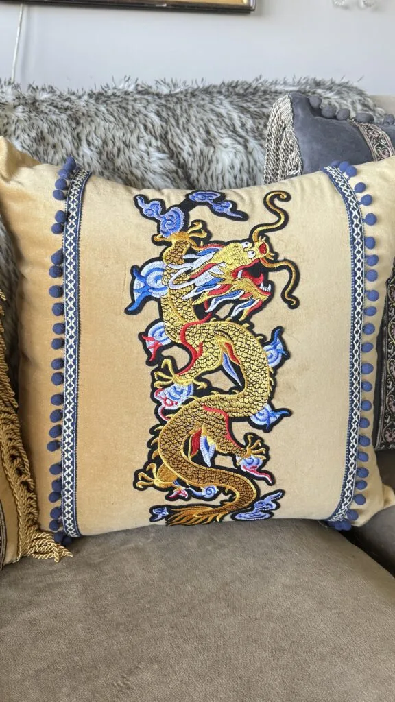 Intricate Japanese-inspired embroidered dragon motif on a custom statement pillow.