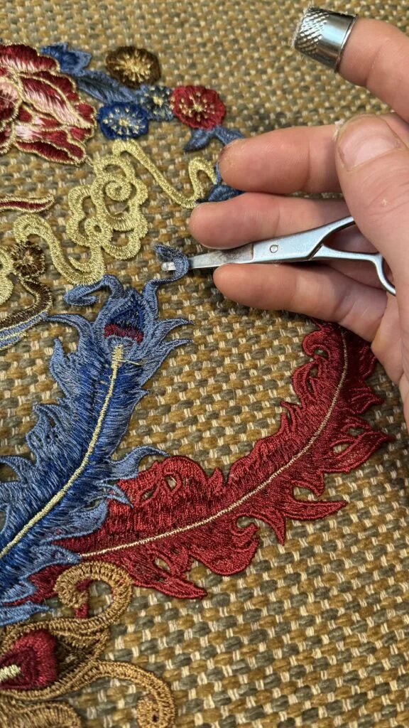 Close-up of premium embroidered applique details on a custom accent pillow.