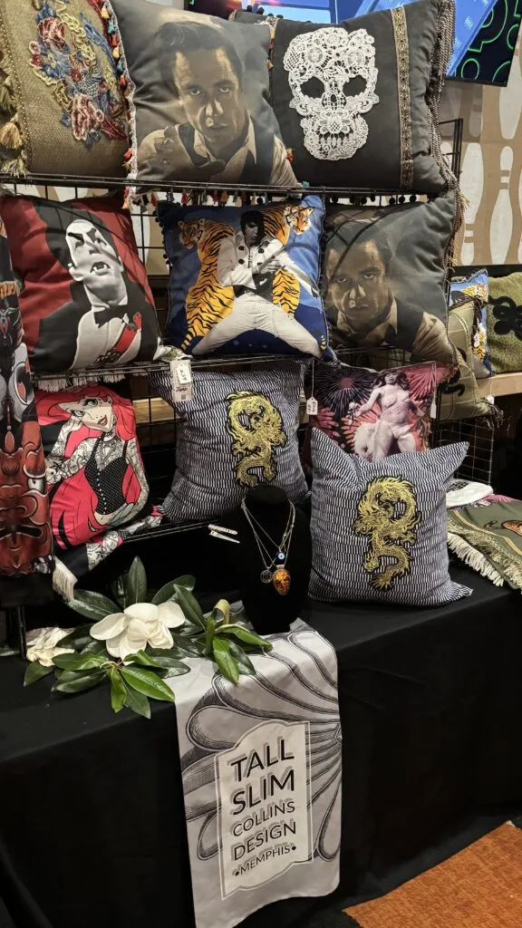 TallSlimCollins custom merchandise display booth showcasing designer pillows at a local market.