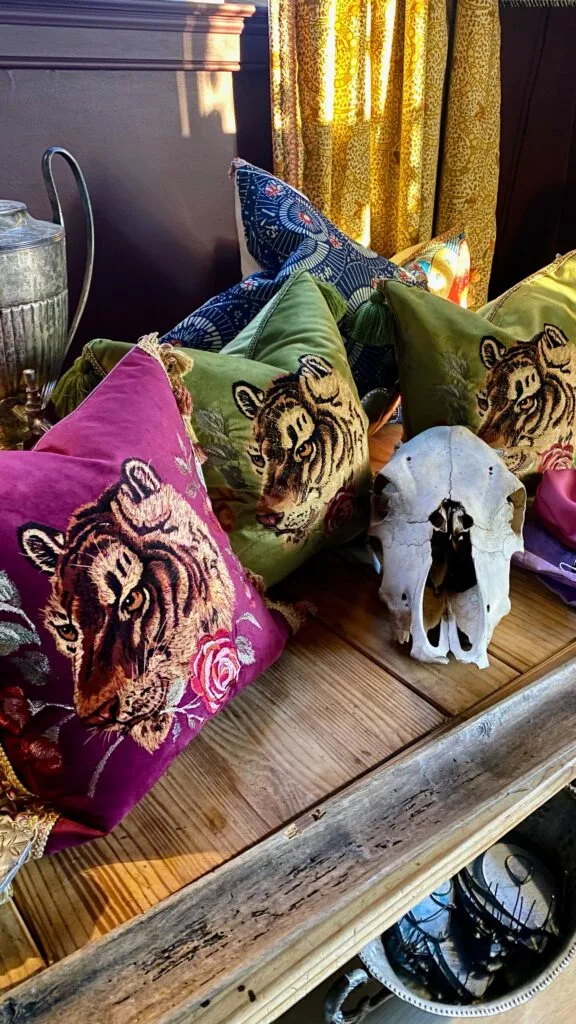 Moody design vignette showcasing luxury velvet pillows alongside eclectic decor.