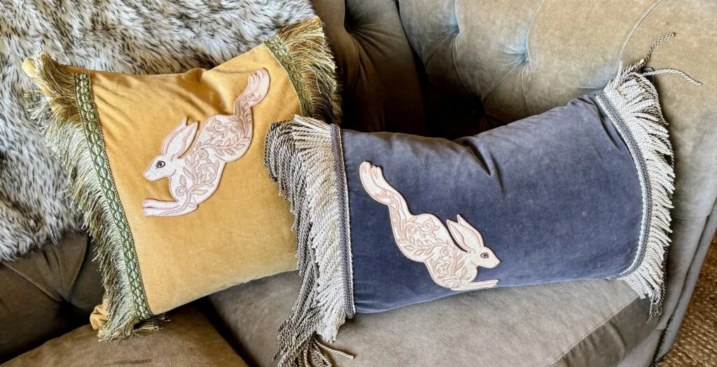 Two luxury custom velvet throw pillows styled perfectly for a residential interior.