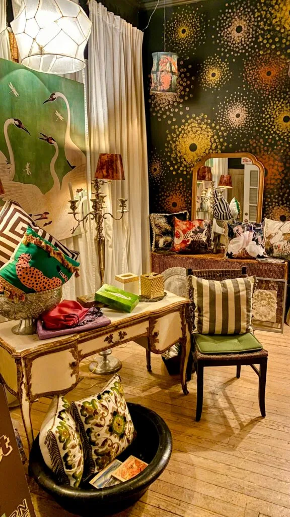 Earth-toned flax and fern custom throw pillows styled in a bright boutique setting.